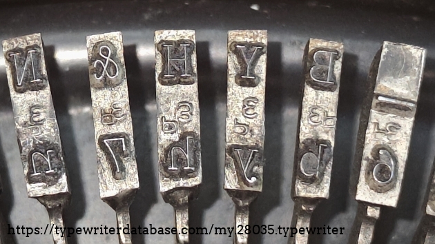 Type slug detail, showing Elite foundry marks.