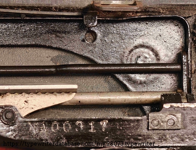 Aft right foot riser, from top, showing weld point and serial number.