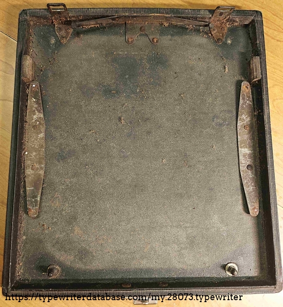 Case bottom, showing attachment points for typewriter.