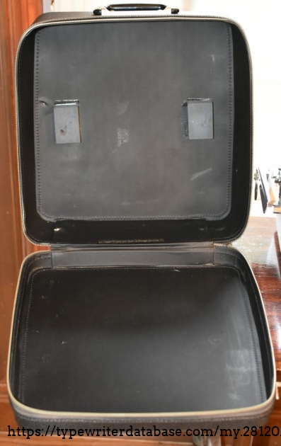 There is no hardware to affix the typewriter to the case - just two blocks of foam
