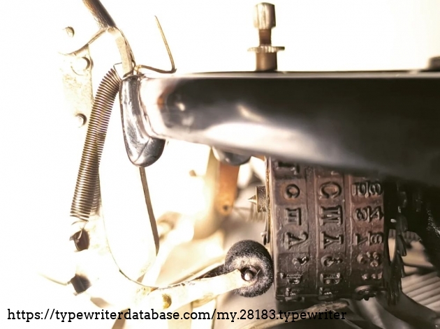 The typewheel strikes the paper. The ink roller is pushed to the side.