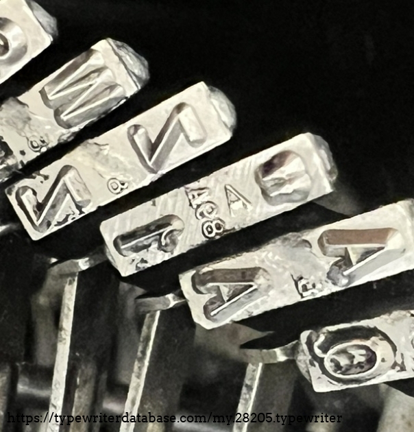 I guess this turns into A98 slugs, and my best guess is a RaRo 98 slugs mentioned in a 1928 catalog, which mentions its availability in Remington typewriters.