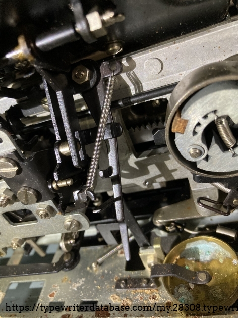 Long side mounted spring.