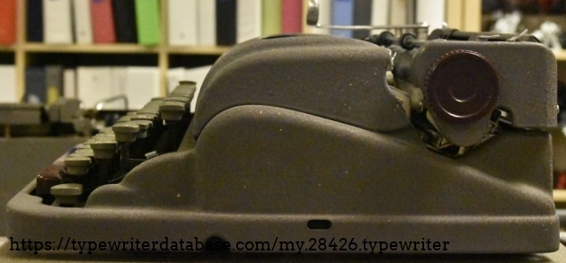 The horizontal slot would normally have the knob for the ribbon advance,  It tilts forward and back to select ribbon direction.