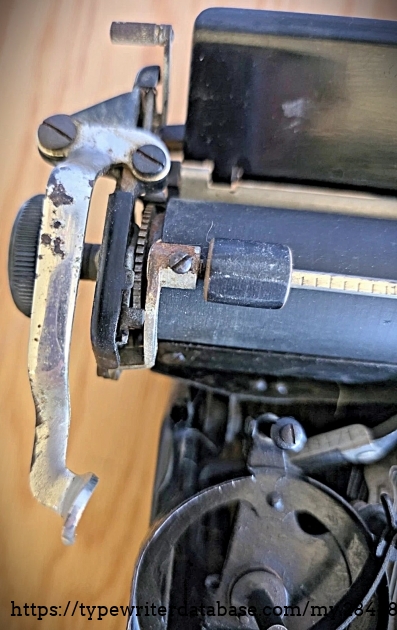 Left carriage end and carriage return lever.