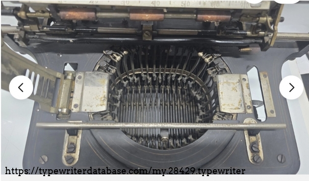 Top-down view of type basket, carriage raised.