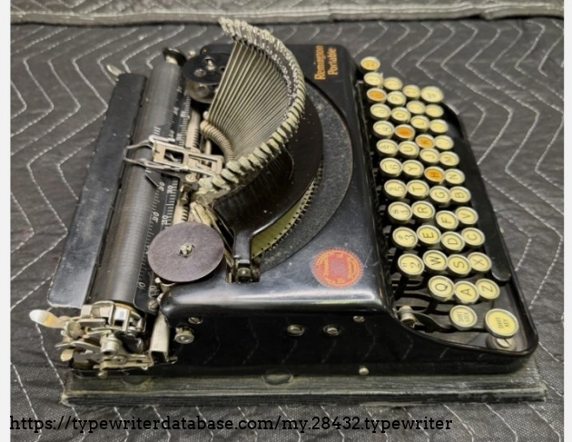 Left broadside, higher elevation, typebars extended.