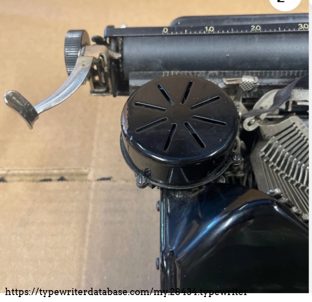 Left ribbon spool cover and carriage return lever.