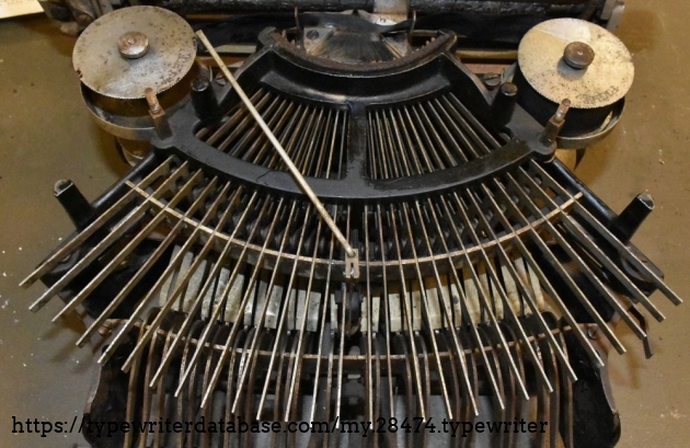 Note the comically simple ribbon advance system.  It seems to work better than some later typewriters.