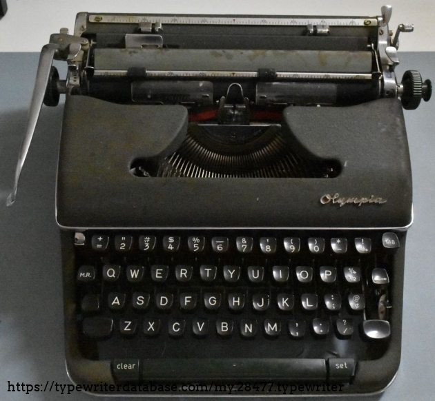 This shows some of the cosmetic issues, with mild surface rust on the paper table and all sorts of discoloration on the right side of the ribbon cover.