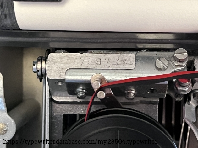 Serial number is located rear of the left ribbon spool.
