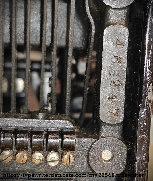 Serial number along the left underside between the feet.