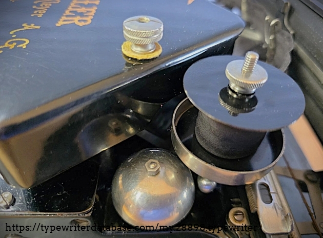 Bell and right ribbon spool cover.