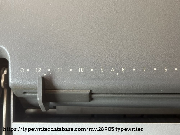 Detail: paper table with auxiliary markings (the circles and triangles) for different paper sizes