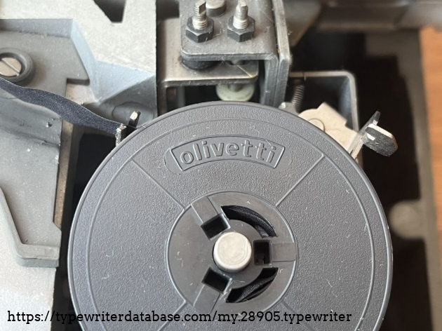 Detail: original ribbon spool with "olivetti" embossing