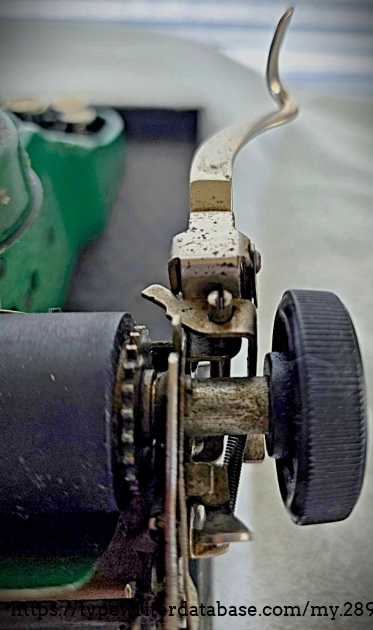 Left carriage end and carriage return lever, aft view.