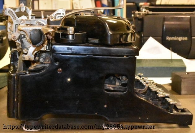 Note the broken left (right?) platen knob, and the custom furniture glides on the feet.