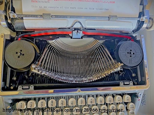 Under the ribbon spool cover.