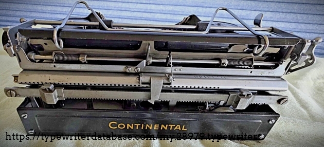 Aft.  The serial number can just be seen, to the right of center.