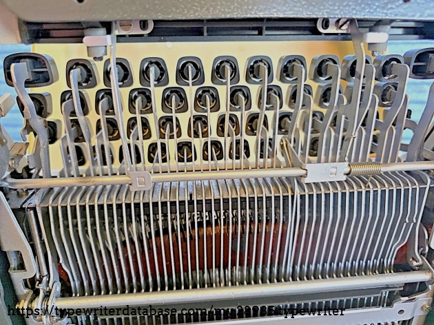Underside, under the keyboard.