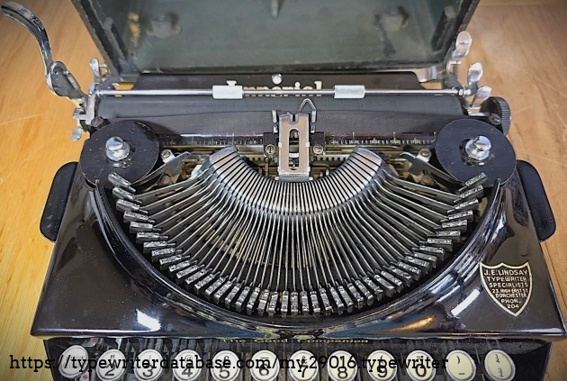 Type basket and carriage, machine in front of case.