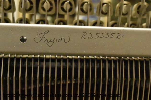 Mysterious engraving.  May date to a time when phone numbers were 'letter - number' .