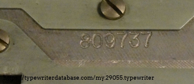 The serial number, which is located under the ribbon cover.