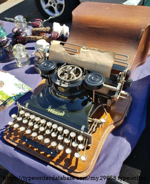 Three-quarter view from the right with the case lid in background.
