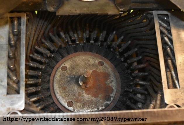 Note the built-in brush in the center of the type basket.  It appears to be on some sort of screw, as it rises as you turn it counter-clockwise.  When fully turned clockwise, the bristles lay below the lower typebars.  I am pretty certain that fully counter-clockwise would cover the upper typebars.
