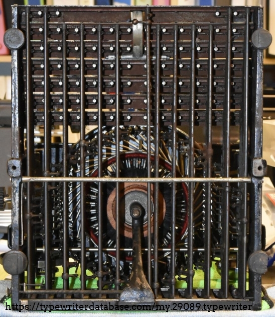 The lower half of the typewriter is dominated by the control arms.  Each key is attached to a rod, which rotates to actuate the correct typebar.
