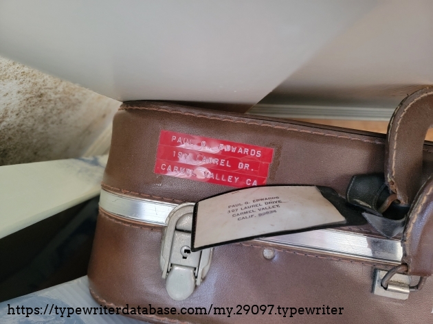 9/28/2026, last day of estate sale arranged by Grasons Co., detail of an old suitcase. In an attempt to find something to identify the Groma by something in its current residence, I did find the name of the original owner in a closet full of suitcases, jumpsuits, and an old army style sleeping bag. I was informed that any items remaining unsold during the estate sale will be kept with the family. It's likely that the Groma will at least stay with the family of Paul G. Edward's. (The address on the suitcase tag is not the same current residence of the Groma in which the estate sale was occurring.)