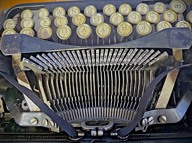 Top-down view from behind, showing basket of type-bars.