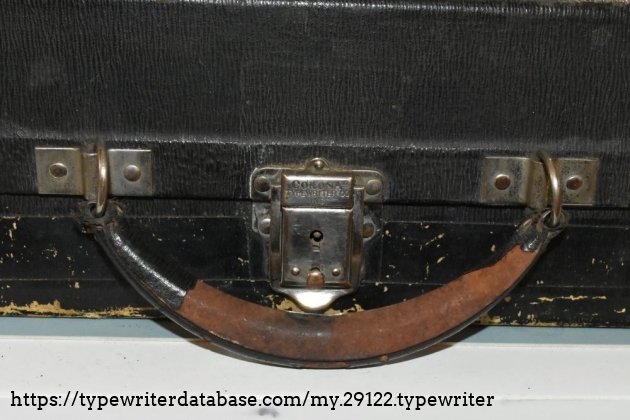 The handle is metal, covered with some sort of paper-like fake leather.