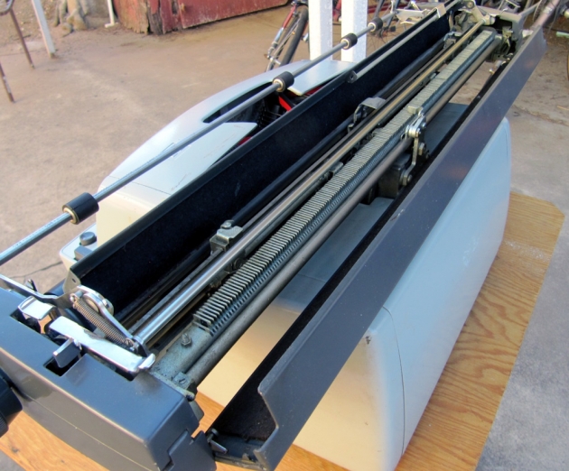 Opened, the carriage gives full access inside. The manual margin stop sliders are ready to hand.