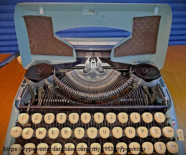 Front view, with ribbon spool cover open.