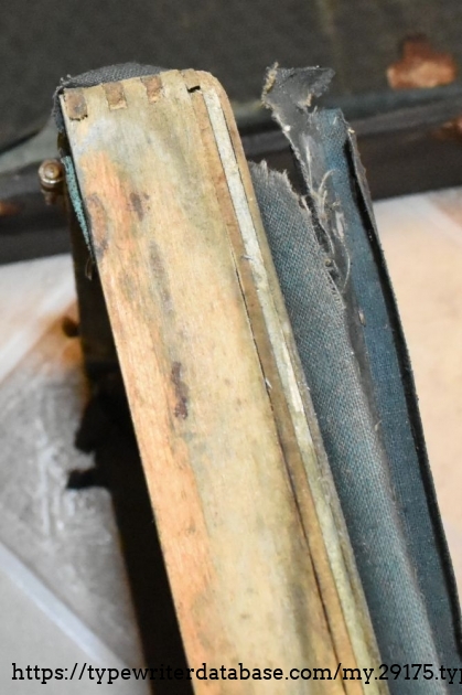 This is the exposed edge of the case bottom, showing the plywood and finger joints - this is after I glued it back together.  The faux-leather covering is peeling all over.