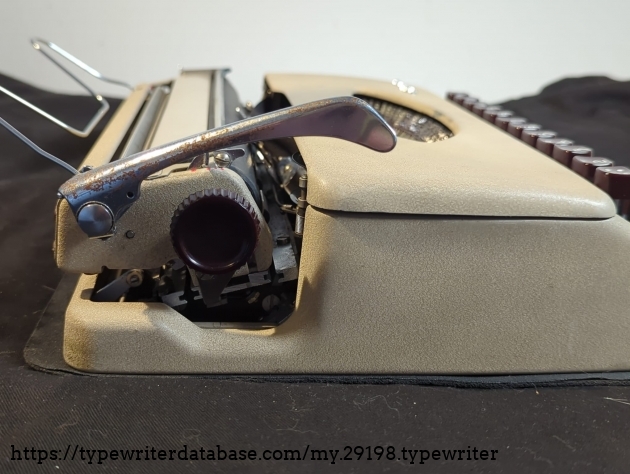 Close-up of the left side of the carriage. Notice the smaller dimpled advance knob typically seen on 1956 models, and the corroded line advance lever...