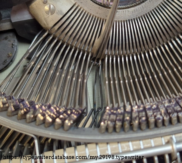 The wire that normally transfers the energy from pushing a key to its corresponding slug, one sheared off where the key lever connects. ( No F's left to give...literally)