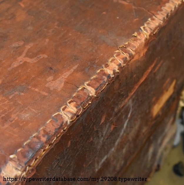 Details of the edge construction.  The wooden panels are notched where each stitch would go to join the leather pieces.  This is a saddle stitch, generally used for hand stitching leather.