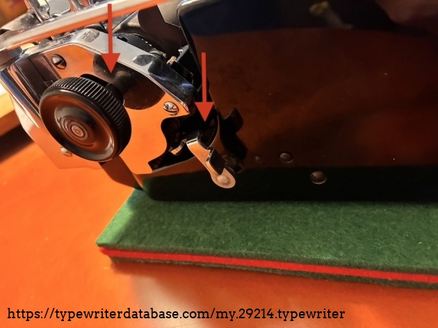 See the window (left arrow) for the platen to be moved for uppercase letters. That is nice because you do not have to lift the whole carriage but just the platen and the paper support.

The right arrow show the carriage lock for transport at your place. (Shipping transport locks are lost.) Guide the carriage to a mostly middle position, move this lever away from you and adjust the carriage 'til it locks. Done in an instant. Safe for storing.