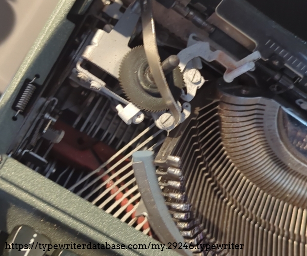 Temporary showcase of the extent of the corrosion. Notice the white rough surface of the ribbon direction switch and parts of the typebar mechanism.