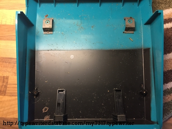 Pre-cleaning, typewriter screws into plastic case