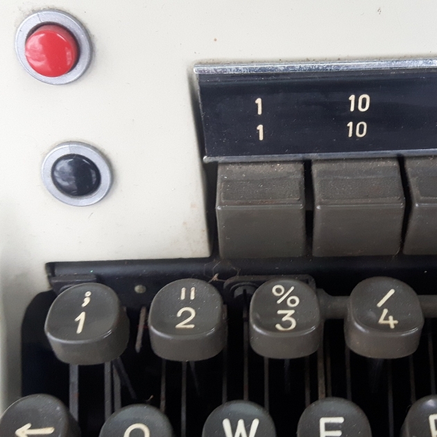 The typewriter came with a black-only ribbon, so I haven't been able to make the buttons do much, but I assume they're for ribbon-colour selection. I envision the red button alerting the Kremlin that someone is typing secret documents on this typewriter.