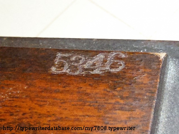 the serial number engraved on the wooden base